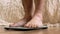 Feet of man stand on scales. Naked male legs stand on scales. Concept of controlling your weight