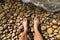 Feet of a man, from a subjective view, in the water at the seashore