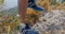 Feet of men wearing trekking shoes climbing rocks