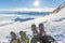 Feet on mountain top in backlight. Hiking boot with crampons for ice and snow climbing.