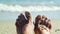 Feet moving fingers, close next to sea luxury vacation