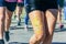 The feet of the participants of the mass run running along the embankment of the river.