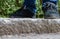 Feet of a person standing on exterior stone steps