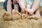 Feet playing with sand on the beach. Conceptual image shot