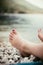 Feet with purple nail polish on the beach, relax