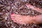 Feet with Red-painted Nails of a Young Woman Relaxing on the Pebbles Beach in Greece