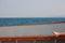 Feet relaxing on a sailboat with ocean background