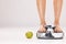 Feet, scale and apple in studio on a gray background with mockup for diet, weightloss or detox. Food, weightscale and