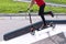 Feet on a scooter. Young girl riding on a cick scooter in skatepark