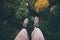 Feet selfie on cliff with forest aerial view