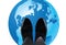 Feet with shiny shoes above globe-