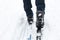 Feet of a skier in ski boots on cross-country skis. Walking in the snow, winter sports, healthy lifestyle. copyspace