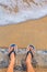 Feet and slippers on the beach