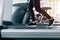 Feet with sneakers of female runner / jogger running on treadmill indoors in action - with motion blur