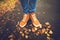 Feet sneakers walking on fall leaves Outdoor