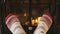 Feet In Socks Warming by Fire in Fireplace Getting Warm and Cozy In Winter
