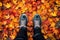 Feet stand in Autumn woods with beautiful Fall foliage colors.