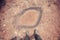 Feet standing in front of dried out puddle.