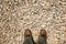 Feet step on gravel background