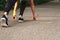 Feet step runner on the road, closeup shoes. Start running on the sidelines. Run outdoor exercise activity concept.