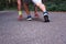 Feet step runner on the road, closeup shoes. Start running on the sidelines. Young handsome man jogging along scenic path in park.