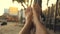 Feet swinging in a hammock, POV. Relaxing on the beach at sunset.