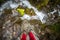 The feet of a tourist stand on a rock above a mountain waterfall. Shevelev.