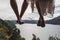 Feet of traveler couple in love above mountain and lake view