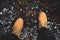 Feet of traveler in yellow boots standing on mountain