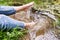 Feet of unrecognizable woman sitting at the lake.