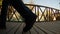 Feet walk past on a wooden platform close-up, water wheel