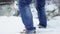 Feet walking in deep snow shot in slow motion. foot steps of hiker is showen among beautiful landscape. a young man