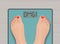 Feet on weighing scales. top view. Health concept.