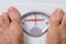 Feet on weight scale indicating overweight