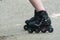 Feet of woman with roller blade on the road