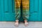 Feet of a woman in sandals. Colorful hippie pants