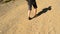 Feet of a woman in sandals walking on stony way or path