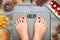 Feet of woman on weighting scale asking for help to avoid the temptation to eat unhealthy food