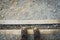 Feet on Wooden storm rain drainage on a footpath