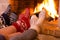 Feet in wool socks near fireplace in winter