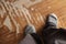 Feet in woolen knitted socks, on an old, shabby parquet. Copy space.