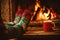 Feet in woollen socks by the Christmas fireplace. Woman relaxes