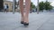 Feet of young business woman in high-heeled footwear going in the city. Female legs in high heels shoes walking in the