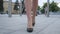 Feet of young business woman in high-heeled footwear going in the city. Female legs in high heels shoes walking in the