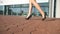 Feet of young woman in high-heeled footwear going in the city. Girl stepping. Female legs in high heels shoes walking in