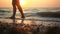 Feet of a young woman walking on the beach at