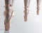 Feets with pink satin pointe shoes by a classic ballerina on tiptoe