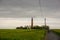 Fehmarn, Germany - 05/26/2020: The Lighthouse Of FlÃ¼gge On The Isle Of Fehmarn With Tourists Cycling Towards It