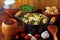 Feijao Tropeiro typical dish of Brazilian cuisine, made with beans, bacon, sausage, collard greens, eggs, on rustic wooden table