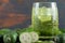 Feijoa fruits and glass of juice on marble table